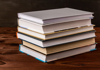 High angle close up of stack of books on wooden table. Books in the library on the table....
