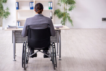 Young male employee in wheel-chair