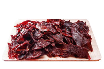 Horse meat jerky, cut into slices, on a wooden board, on a white background