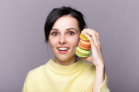 Portrait Of Gorgeous Shirtless Young Woman Eating Macaron Cookies 