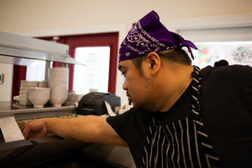 Asian Filipino adult man chef cook prepare in restaurant