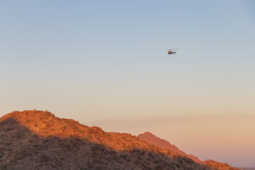Rescue helicopter over mountain