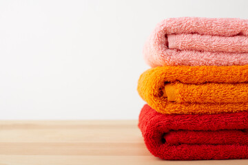 Obraz na płótnie Canvas Bright colorful towels on table in the bathroom. Photo of towels with copy space