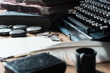 Fototapeta na wymiar vintage desk with typewriter, ink pen, pocket watch, old glasses and vintage textured blank writing postcard