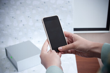 female hands with phone close-up on the background of the box