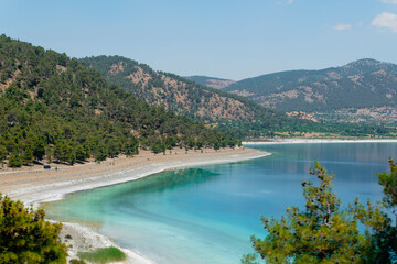 Famous white-colored lake Salda beach and the hills in background, Burdur, Turkey.