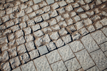 Nested pavers of various colors, around the grass is green, chic garden