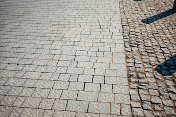 Nested pavers of various colors, around the grass is green, chic garden