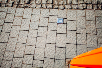 Nested pavers of various colors, around the grass is green, chic garden
