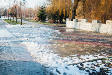 Nested pavers of various colors, around the grass is green, chic garden