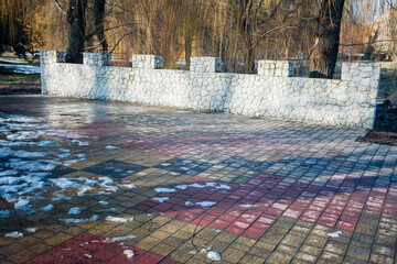 Nested pavers of various colors, around the grass is green, chic garden