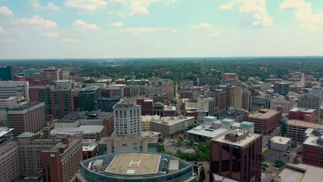 Scenic aerial view of downtown Grand Rapids Michigan including sky scrappers and crane 02