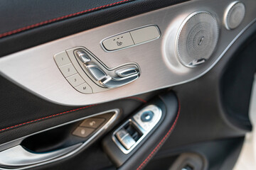 Side door settings with visible leather upholstery and red thread lining. Numerous chrome and aluminum elements.