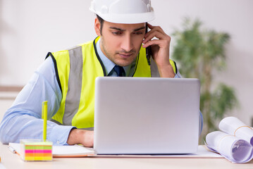 Young male architect working in the office