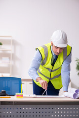 Young male architect working in the office