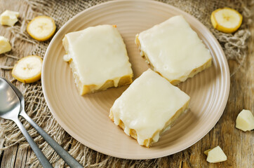 White chocolate banana bars in a plate with glasses of coffee