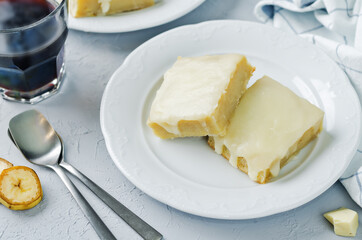 White chocolate banana bars in a plate with glasses of coffee