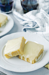 White chocolate banana bars in a plate with glasses of coffee