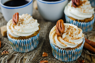 Carrot cinnamon cupcakes with cream cheese and pecan nuts