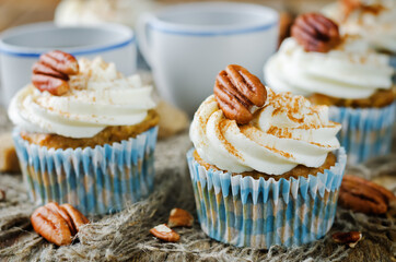 Carrot cinnamon cupcakes with cream cheese and pecan nuts