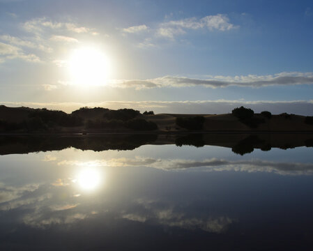 Awesome sunrise with reflections on the lagoon, Maspalomas, south of Gran Canaria, Canary Islands