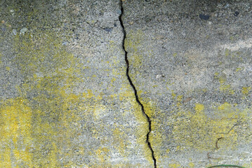 yellow stain cement wall with single crack