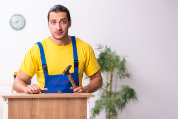 Young male carpenter working indoors