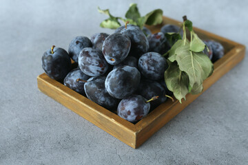 Plums on a wooden tray