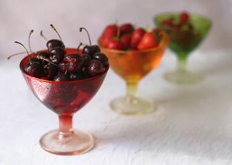Still life with cherries in glass vases