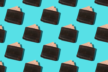 Colorful pattern: euro banknotes in an old leather wallets on blue background, close-up with hard shadow