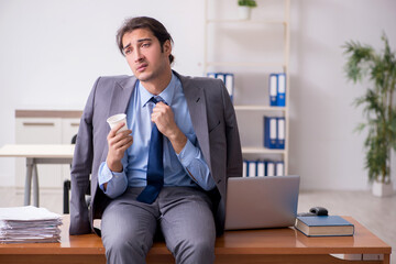Young male employee sleeping in the office