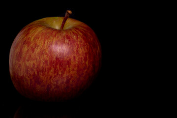 Isolated still life apple in soft light on a black background 
