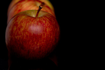 Isolated still life apple in soft light on a black background 