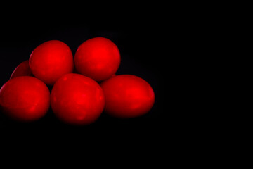 bunch of isolated cherry tomatoes on a black background