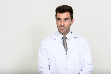 Portrait of handsome Hispanic man doctor thinking