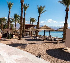Relaxing sunny beach for all the family in Eilat - famous tourist resort and recreation city in Israel