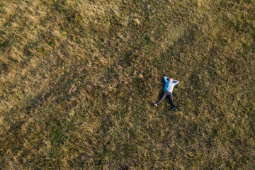 The guy is resting on the grass. View topvacationl, young