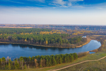 Lake with blue water view from the top. Autumn lake shot from a quadrocopter. Lake in the forest