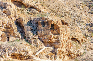 Monastic cave cells in mountain wall of the Kidron Stream. View from terrace of the Greek Orthodox...