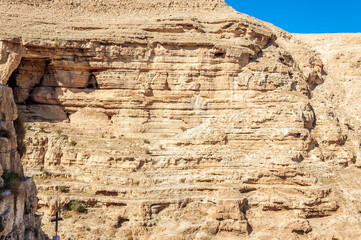 Mountain wall in the Wadi Kelt gorge in the Judean desert near the monastery of St. George Hosevit (Mar Jaris). Palestine, Israel.