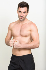 Fototapeta premium Portrait of handsome muscular Hispanic man shirtless