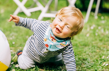 Portrait of happy baby crawling on grass