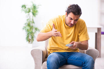 Young man watching tv at home