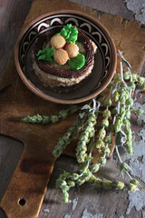 Sweet dessert in a ceramic bowl with provencal herbs on an old wooden surface