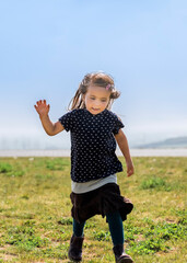 Girl running on top of hill