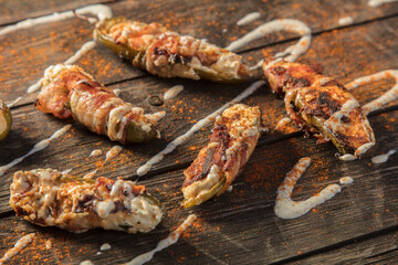 Cream Cheese Filled Bacon Wrapped Jalapeno Poppers On Wood Background