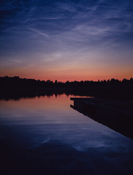 Noctilucent clouds over a lake in the twilight