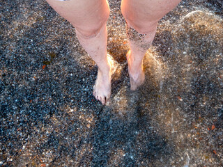 Female feet on the sand at the beach