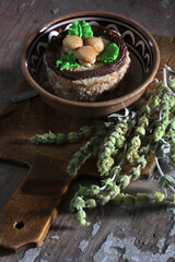 Sweet dessert in a ceramic bowl with provencal herbs on an old wooden surface