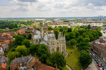 Selby Abbey North Yorkshire England. Drone photograph of the Abbey looking at the North and East side in sun with Selby town behind. 